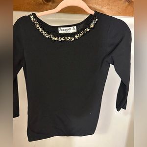 Joseph A black right fitting top with cheetah print details at neckline